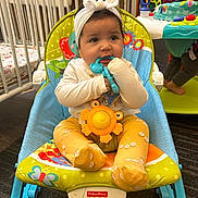 Aitana Sánchez joined the competition — help win amazing prizes! baby, baby_rocker, chewing, child, clothing, colorful, cute, fisher_price, floor, footwear, headband, indoor, infant, person, play_area, playtime, seat, smiling, toy, yellow_leggings