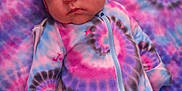 Layla is registered to the contest to win money with this photo: baby, blanket, blue, bonnet, child, clothing, cute, fabric, face, headwear, infant, newborn, pattern, person, pink, portrait, resting, sleepwear, soft, tie_dye