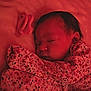 Layla is registered to the contest to win money with this photo: baby, bed, blanket, child, closeup, cute, face, floral_clothing, indoors, infant, newborn, peaceful, portrait, red_light, resting, sleep, sleeping, soft, toy, young