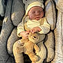 baby, sleeping, infant, teddy_bear, plush_toy, car_seat, knitwear, hat, cozy, child, cute, peaceful, soft_lighting, indoors, cushion, comfort, resting, small_child, adorable, portrait