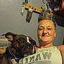 animal, brown_dog, casual, chain_collar, closeup, companion, dog, face, furniture, indoor, person, pet, portrait, relaxed, shelf, smiling, tank_top, tools, wall, woman