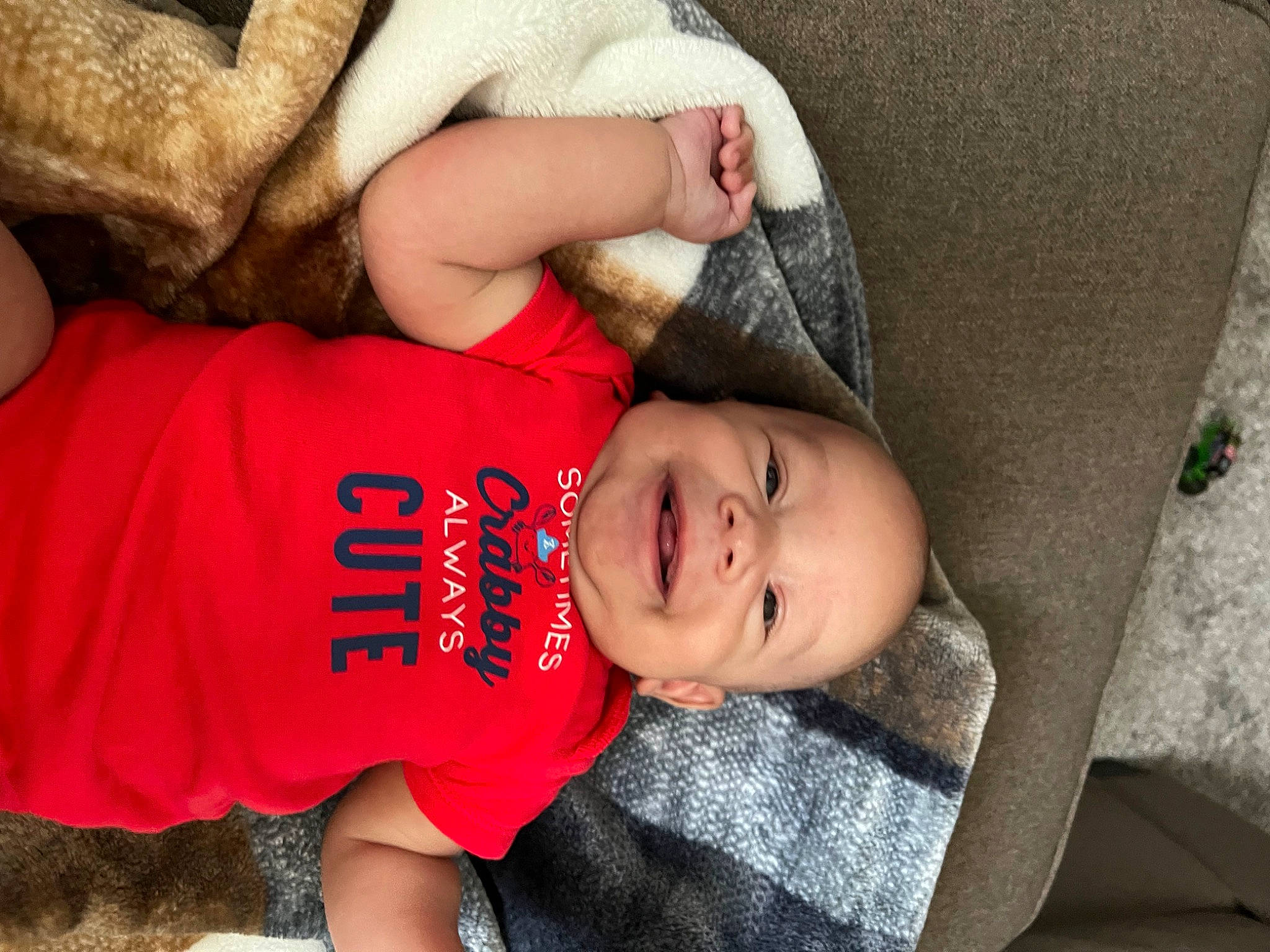 Kameron joined the competition — help win amazing prizes! baby, baby_toddler_clothing, cap, child, comfort, elbow, fun, grass, happy, hat, human_body, joy, nose, person, plant, sitting, skin, sleeve, smile, t_shirt