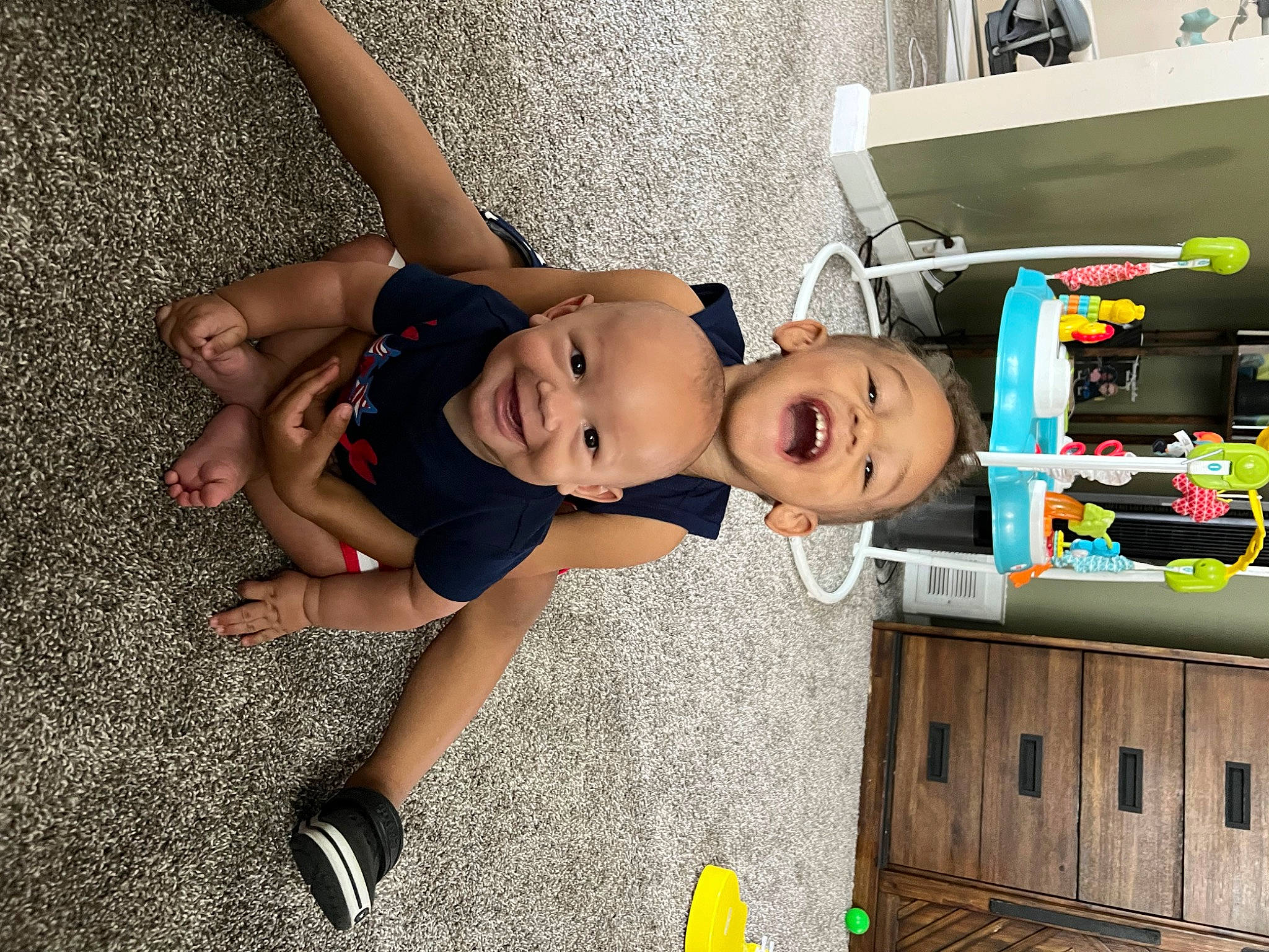 Kameron is registered to the contest to win money with this photo: automotive_design, automotive_exterior, baby, baby_products, child, flooring, fun, hat, house, human_leg, joy, leisure, machine, person, play, sandal, shorts, smile, tire, toddler