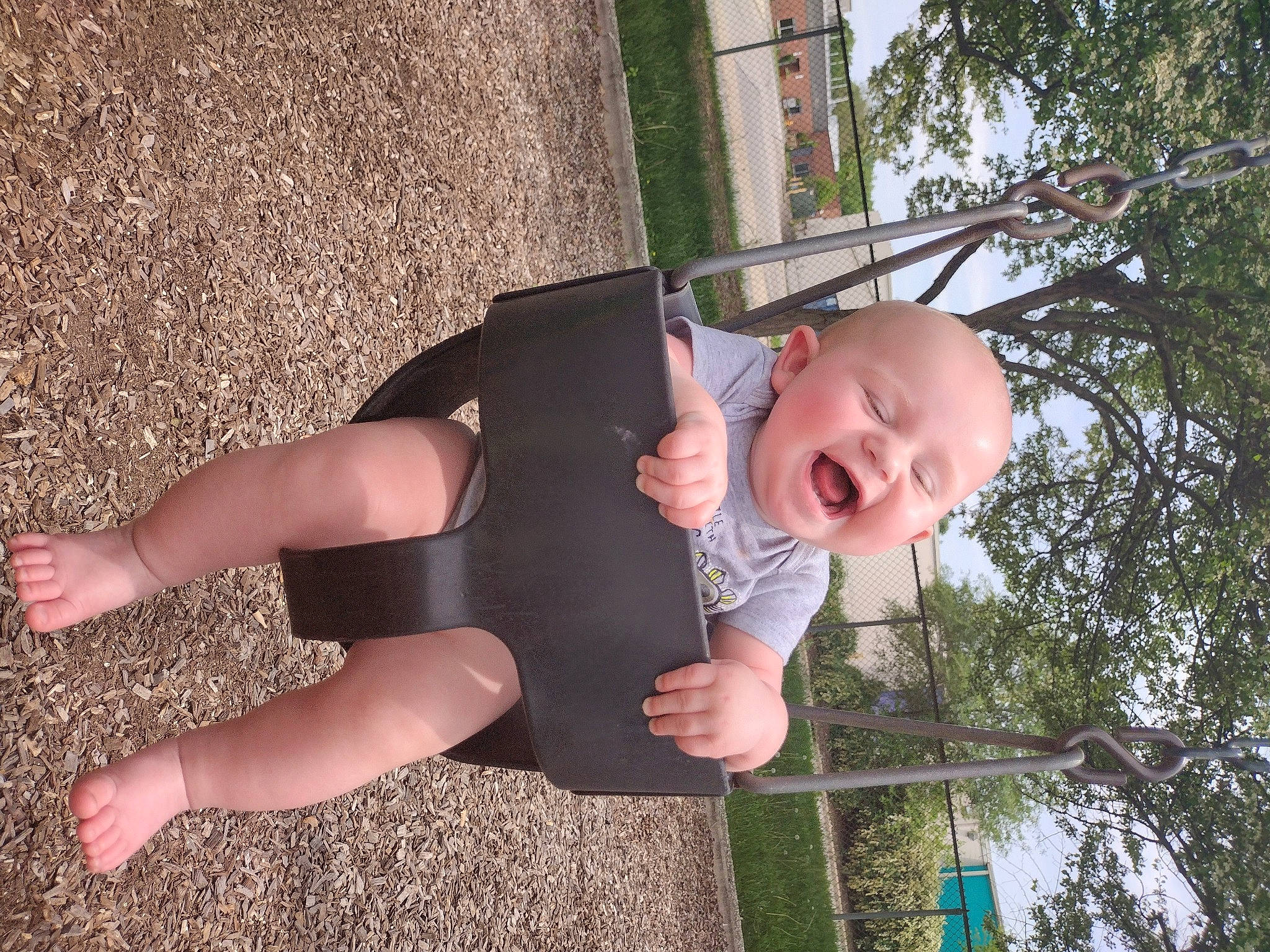 Patrick James Clark is registered to the contest to win money with this photo: baby_toddler_clothing, calf, foot, fun, grass, happy, human_body, human_leg, knee, leaf, leisure, people_in_nature, person, plant, sky, smile, sock, thigh, toddler, tree