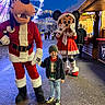 Petru a rejoint le concours — aidez-le/la à gagner de superbes lots ! child, mascot, goofy, minnie_mouse, holiday_costume, santa_outfit, ferris_wheel, night, festive_lights, market_stall, beanie, sneakers, jeans, smiling, outdoor, people, winter_clothing, celebration, amusement_park, fun