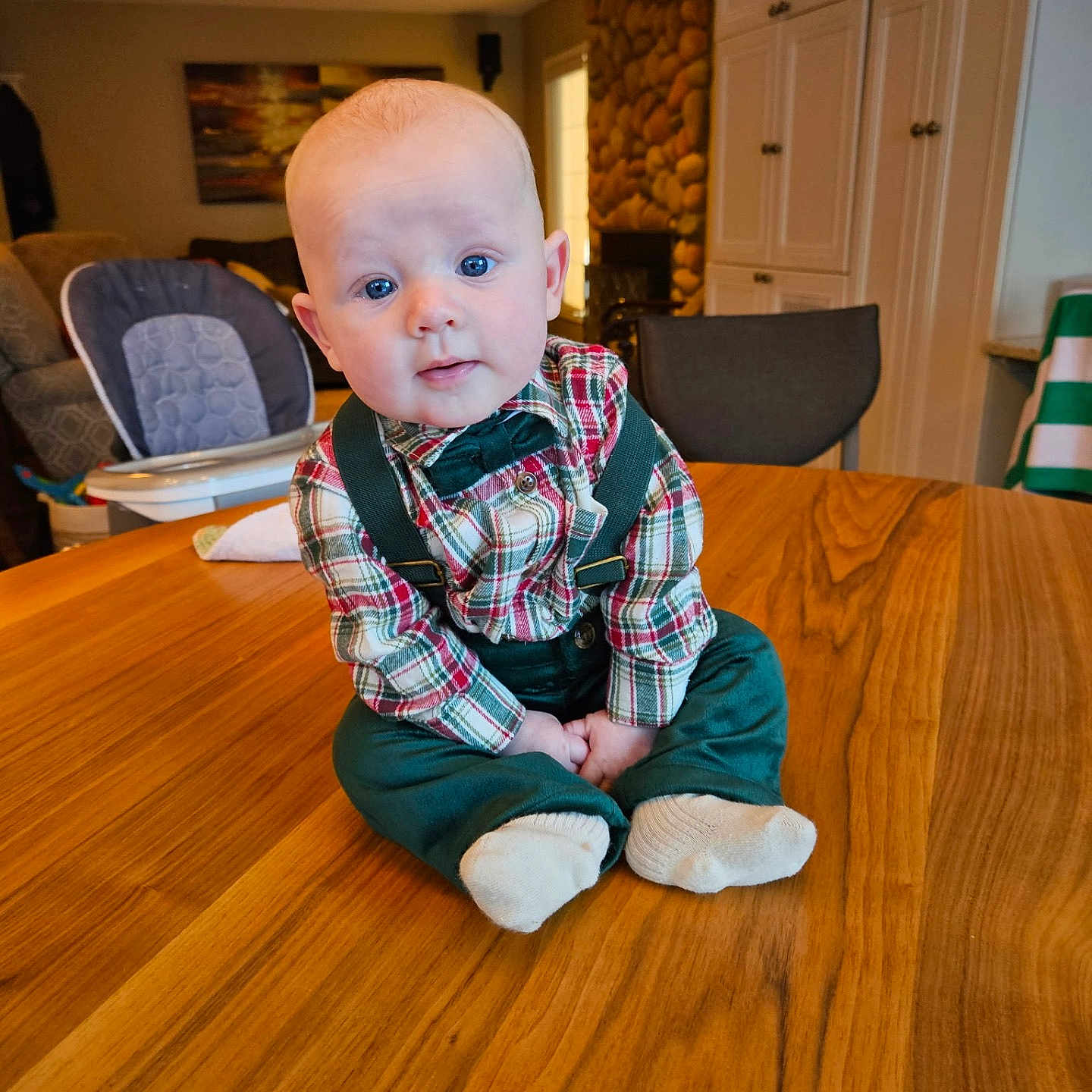 Stetson joined the competition — help win amazing prizes! baby, bow_tie, cabinet, chair, child, couch, curious, cute, high_chair, indoor, living_room, person, plaid_shirt, portrait, sitting, stone_wall, suspenders, table, window, wood