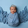 newborn, baby, infant, wrapped, blue_blanket, headband, sleeping, peaceful, portrait, studio, soft_texture, fabric, cute, angelic, child, sweet, background, closeup, smile, resting