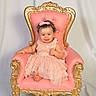 Grace is registered to the contest to win money with this photo: baby, background, chair, child, clothing, cute, dress, fabric, girl, gold, happy, headband, indoor, people, pink, portrait, sitting, smile, throne, toddler