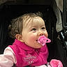 Grace is registered to the contest to win money with this photo: baby, blanket, child, clothing, cute, face, happy, head, indoor, infant, jacket, pacifier, person, pink, portrait, smile, soft, stroller, warm, young