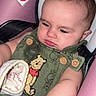 baby, button, car_seat, child, child_safety, closeup, clothing, cute, fabric, green_outfit, indoor, infant, person, pink, portrait, seatbelt, serious_expression, toddler, winnie_the_pooh, young_child