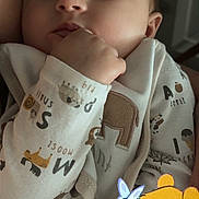 Anora is registered to the contest to win money with this photo: baby, infant, sleeping, sleepy, portrait, close_up, face, hand, fist, onesie, clothing, indoor, warm_lighting, winnie_the_pooh, cartoon, plush_character, cuddly, peaceful, parent, cozy