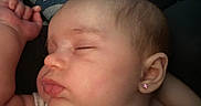 Anora is registered to the contest to win money with this photo: baby, sleeping, earring, face, infant, peaceful, closeup, skin, hand, cheek, nose, lips, ear, child, newborn, resting, soft, pattern, blanket, cute