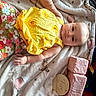 Anora is registered to the contest to win money with this photo: baby, infant, child, yellow_top, floral_pants, blanket, balloons, teddy_bear_pattern, soft_toys, blocks, milestone, five_months, cute, lying_down, indoors, portrait, smiling, baby_clothes, baby_face, baby_hand