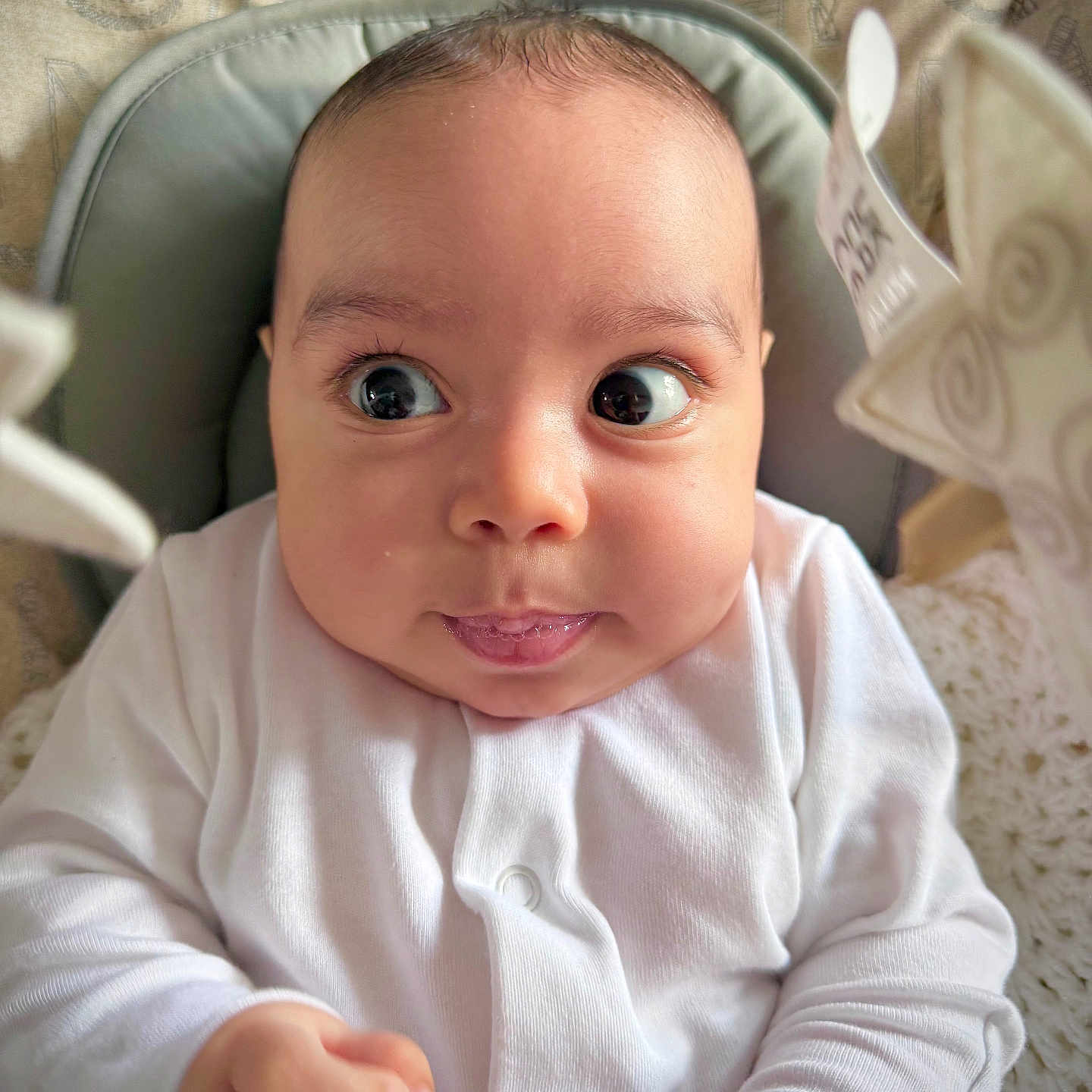 John joined the competition — help win amazing prizes! baby, child, cozy, cushion, cute, expression, face, hands, head, indoor, infant, newborn, person, portrait, seat, skin, soft_lighting, warm, white_clothing, wide_eyes