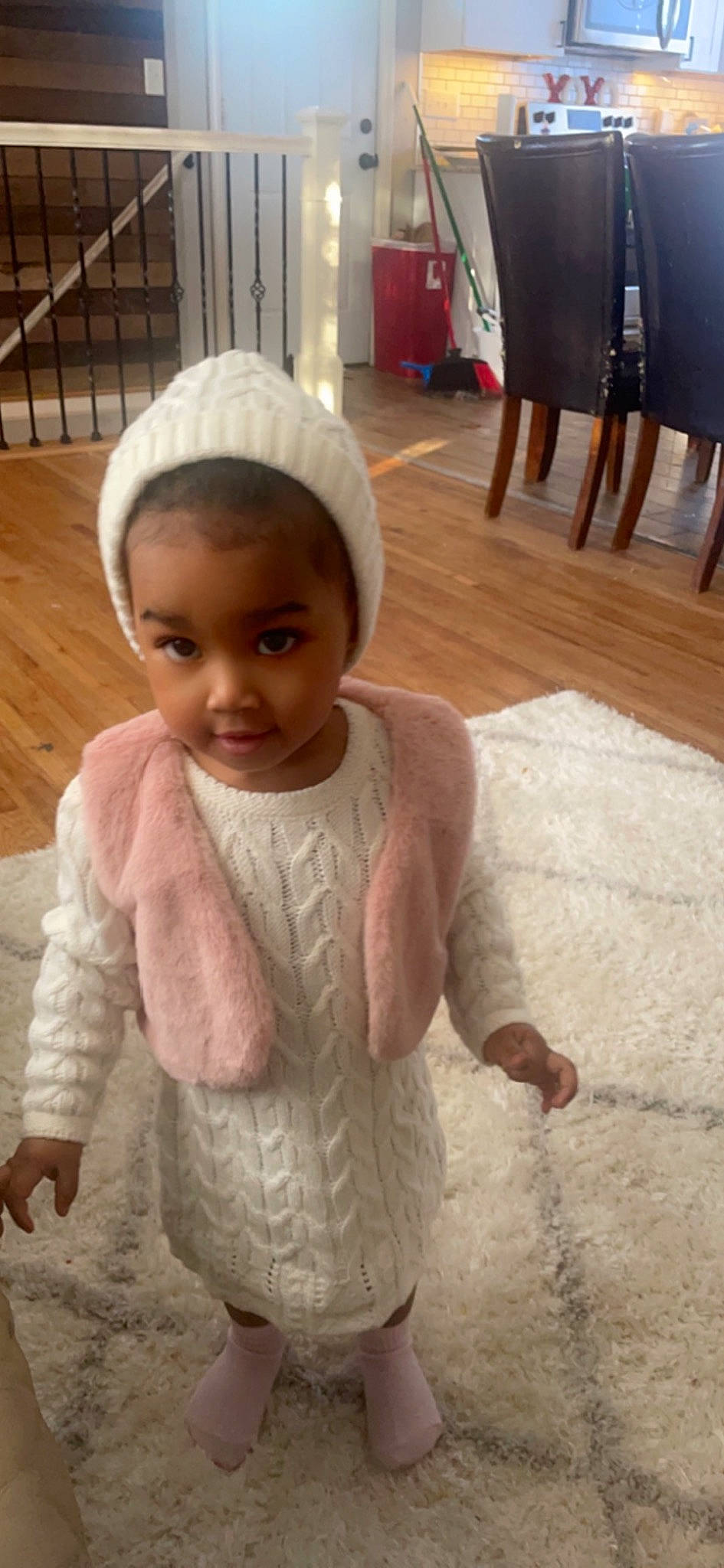 Iliyah is registered to the contest to win money with this photo: baby_toddler_clothing, child, dress, eye, floor, flooring, fun, happy, hardwood, head, human_body, person, room, sitting, skin, sleeve, toddler, white, wood, wood_stain