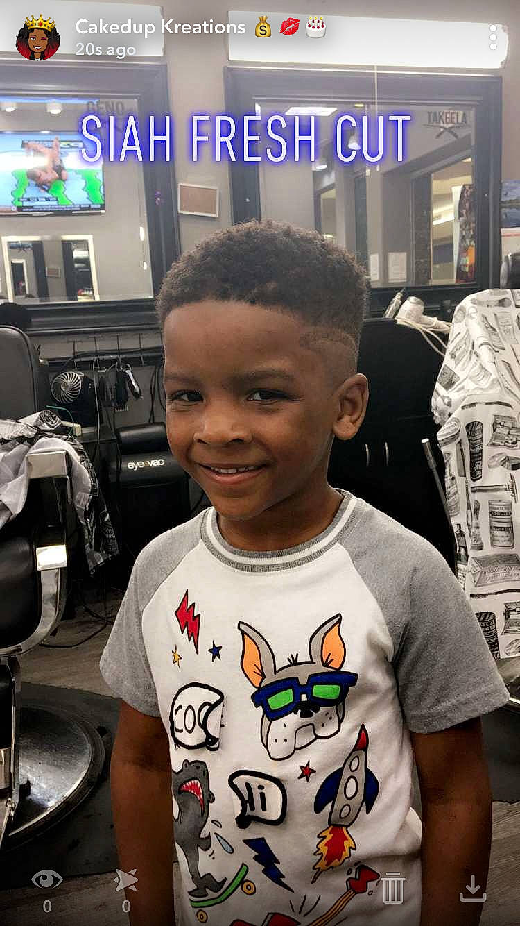Isiah Redmond is registered to the contest to win money with this photo: arm, child, cool, ear, forehead, fun, hairstyle, joy, person, photo_caption, photography, t_shirt, top