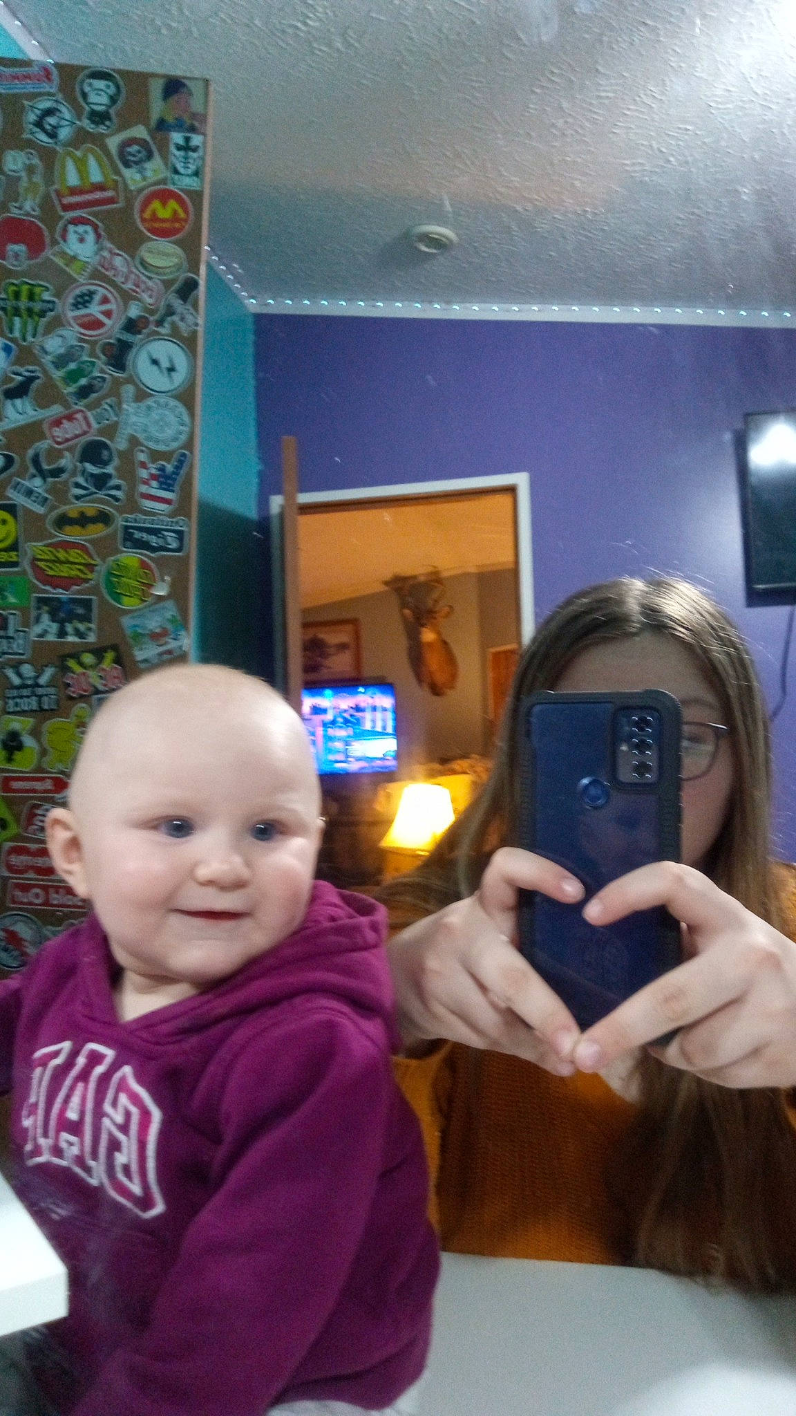 Brynlee joined the competition — help win amazing prizes! audio_equipment, baby, child, event, flooring, fun, happy, hoodie, jacket, joy, leisure, person, personal_protective_equipment, play, purple, room, selfie, sitting, smile, toddler