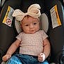 Brenleigh joined the competition — help win amazing prizes! baby, child, infant, car_seat, headband, bow, pink_shirt, denim_shorts, cute, smile, face, clothing, seat, sitting, indoor, person, young_child, comfortable, adorable, portrait
