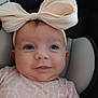 Brenleigh is registered to the contest to win money with this photo: baby, infant, headband, bow, pink_clothing, patterned_clothing, face, eyes, smile, seat, cushion, child, cute, portrait, indoors, closeup, happy, apparel, headwear, person