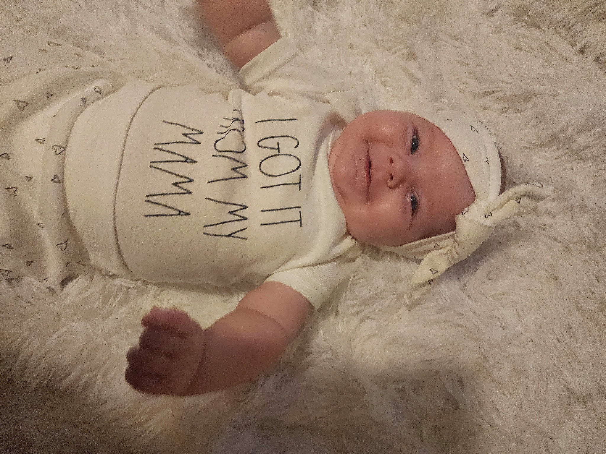 Joslyn is registered to the contest to win money with this photo: arm, baby, baby_toddler_clothing, child, comfort, dress, font, fur, grass, happy, head, headgear, headwear, human_body, joy, linens, pattern, person, portrait_photography, skin