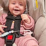 Patsy is registered to the contest to win money with this photo: baby, cabinets, car_seat, child, cute, face, furniture, hand, happy, head, indoor, infant, knitwear, person, pink_clothing, safety, seatbelt, smiling, toy, young_child