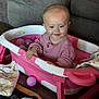 baby, child, pink_sweater, toy_bathtub, colorful_balls, blanket, floor, smiling, indoor, cozy, plastic, playing, cute, toddler, childhood, furniture, couch, wood_floor, happy, person