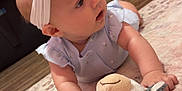 Patsy joined the competition — help win amazing prizes! baby, blue, carpet, child, clothing, crawling, curious, cute, floor, headband, home, indoor, infant, person, pink, plush_toy, room, soft_toy, toy, wood_floor
