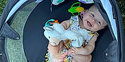 Patsy is registered to the contest to win money with this photo: baby, child, clothing, cute, fan, grass, greenery, happy, infant, outdoor, pacifier, plastic_toy, playpen, playtime, relaxing, smiling, stuffed_animal, summer, sunshine, toy