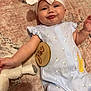 Patsy is registered to the contest to win money with this photo: baby, carpet, child, cute, expression, floral_pattern, headband, indoor, infant, laying_down, onesie, person, playful, portrait, pout, six_months, soft_toy, stuffed_animal, wooden_sign, yellow_chick