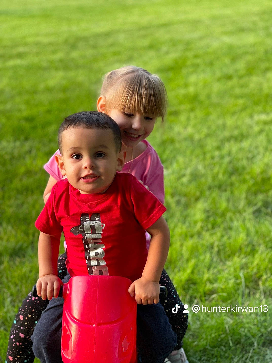 Marcus is registered to the contest to win money with this photo: baby, baby_toddler_clothing, child, face, fun, gesture, grass, grassland, happy, joy, lawn, leisure, luggage_and_bags, people_in_nature, person, plant, recreation, shorts, sleeve, smile
