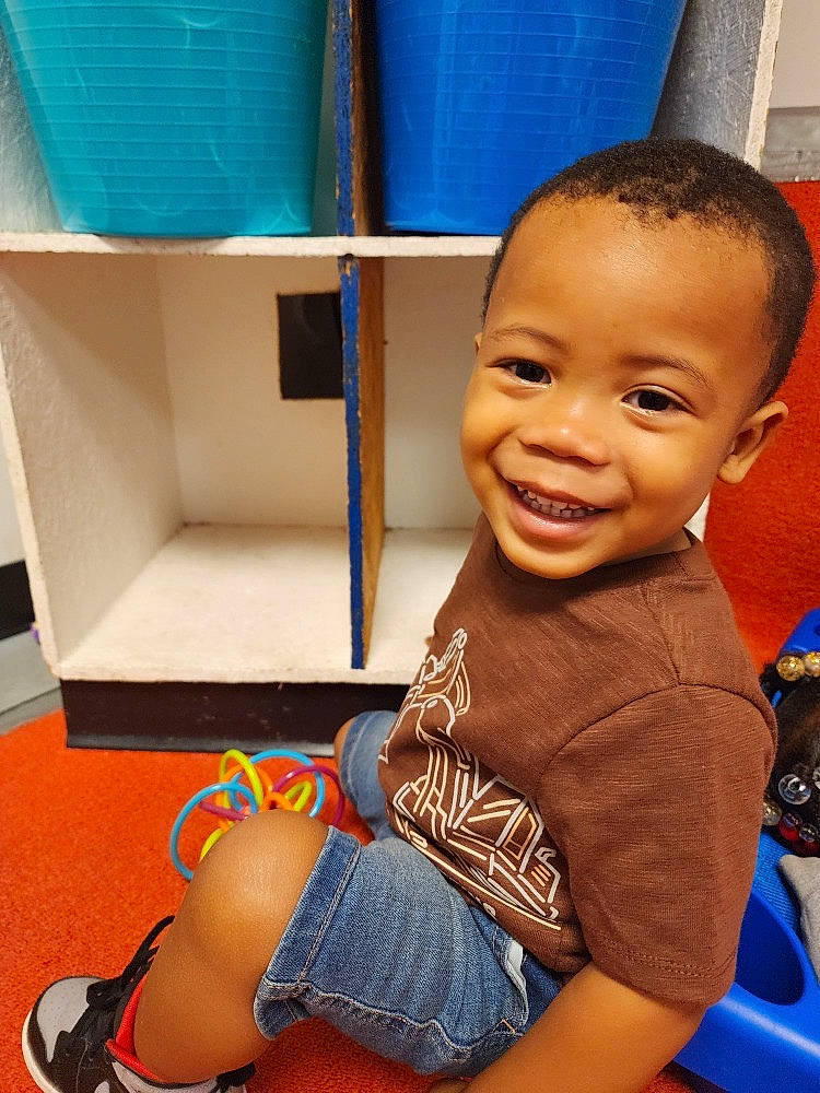 Zion joined the competition — help win amazing prizes! baby_toddler_clothing, blue, child, electric_blue, face, flooring, fun, happy, human_leg, joint, joy, knee, leisure, person, sitting, skin, smile, t_shirt, thigh, thumb