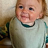 Callum is registered to the contest to win money with this photo: baby, child, infant, smiling, portrait, close_up, blue_eyes, red_hair, face, eyes, drool, bib, clothing, sitting, indoors, soft_lighting, happy, adorable, head, photography