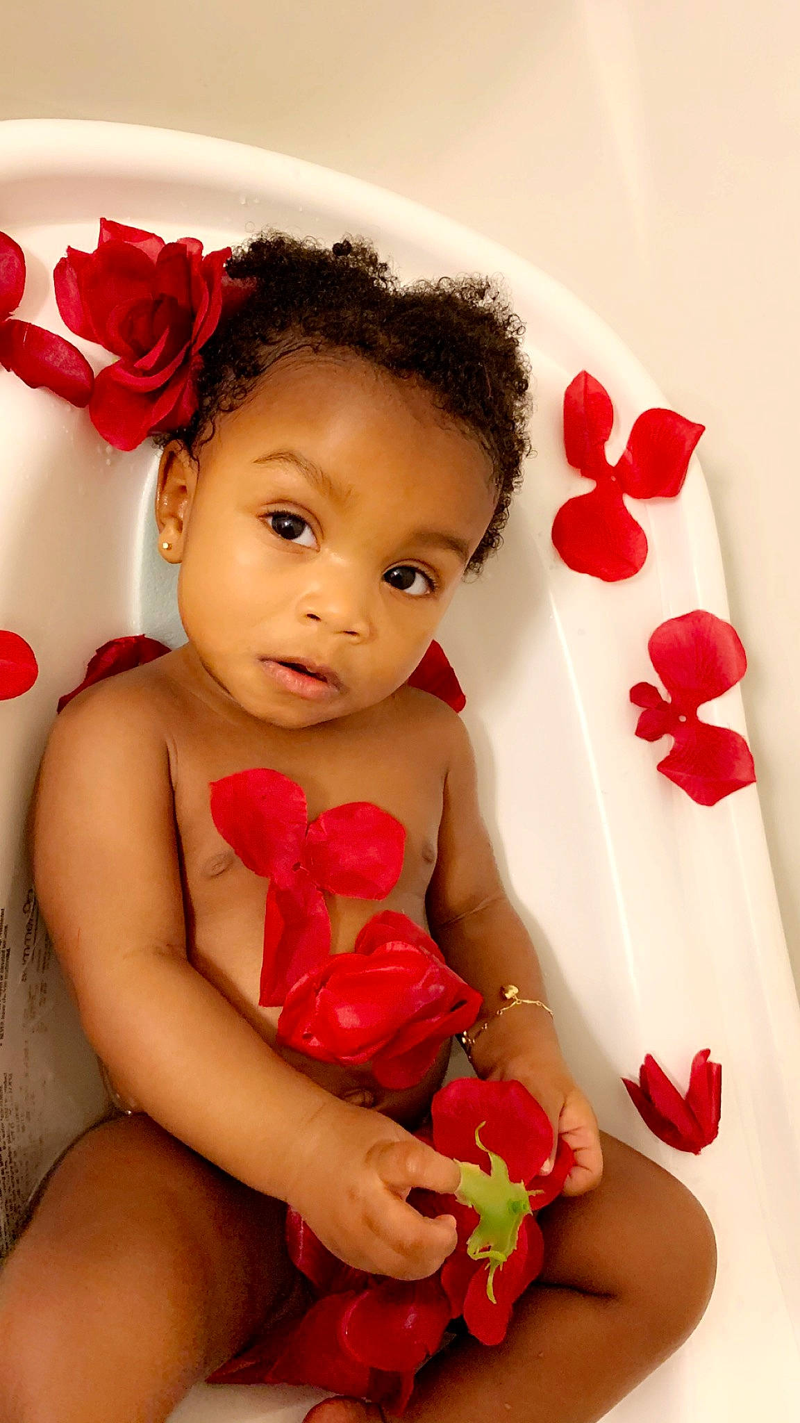 Jalyn is registered to the contest to win money with this photo: baby, beauty, cheek, child, child_model, finger, flower, hair_accessory, happy, headband, lip, person, petal, photography, plant, red, rose, rose_family, skin, toddler