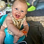 Ventus is registered to the contest to win money with this photo: baby, infant, smiling, blue_baby_seat, orange_spoon, messy_face, home_interior, candid, happy, child, sitting, blanket, soft_toys, floor, clothing, cute, face, arm, foot, playful
