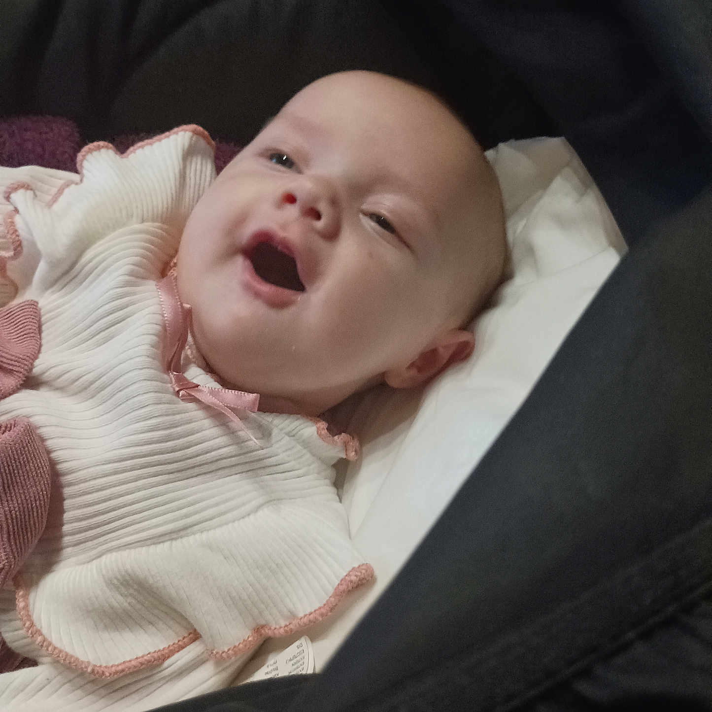 Maggy Paillet Boyer participe au concours pour gagner de l'argent avec cette photo : baby, child, closeup, comfort, cozy, cute, face, happy, head, indoors, infant, lying_down, mouth_open, person, pink_trim, portrait, skin, smiling, soft_fabric, white_clothing