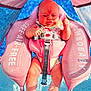 baby, infant, pool, water, float, pink, safety_harness, sunlight, summer, outdoor, child, cute, swimming, blue, legs, seat, small, person, bright, relaxing