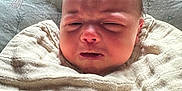Karsyn is registered to the contest to win money with this photo: baby, infant, swaddle, blanket, face, head, expression, closeup, person, newborn, bed, fabric, soft, skin, indoors, human, cute, sleepy, resting, wrapped