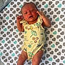 Karsyn joined the competition — help win amazing prizes! baby, infant, swimsuit, blanket, heart_pattern, mesh, playpen, skin, person, child, legs, feet, arms, cute, indoors, resting, yellow_clothing, patterned_clothing, newborn, relaxing
