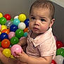 baby, ball_pit, child, colorful_balls, curious, cute, expression, face, hands, indoor, pink_shirt, play, portrait, recreation, short_hair, sitting, skin, toddler, toy, young_child