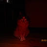 cat, feline, animal, pet, indoor, floor, wooden_floor, dim_light, red_light, fluffy, sitting, quiet, dark, shadow, timestamp, date, mysterious, household, domestic, quiet_moment