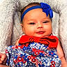baby, infant, child, smiling, headband, bow, blanket, floral_dress, red, blue, white, cute, cozy, plush, portrait, indoors, person, face, happy, sitting
