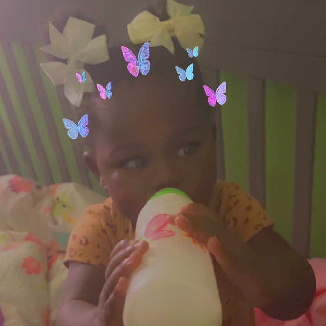 Kaziah is registered to the contest to win money with this photo: baby, balloon, bed, beverage, bodypart, clothing, crib, egg, face, finger, food, furniture, hand, hat, head, indoors, infantbed, person, photography, portrait