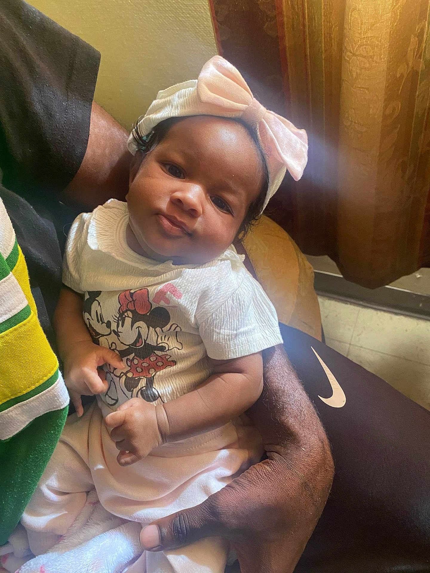 Kyomi is registered to the contest to win money with this photo: baby, child, infant, person, arm, hand, clothing, bow, headband, shirt, cartoon_character, minnie_mouse, sitting, indoor, curtain, light, skin, face, cute, portrait