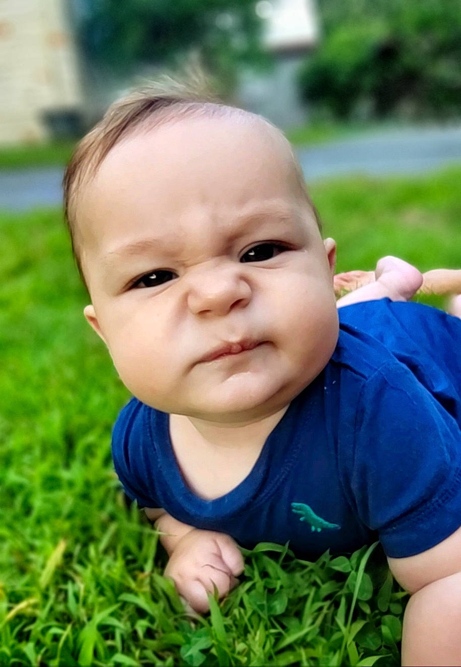 Asa is registered to the contest to win money with this photo: baby, baby_toddler_clothing, child, electric_blue, face, flash_photography, fun, grass, grassland, happy, head, lawn, leisure, nose, people_in_nature, person, plant, recreation, sitting, skin