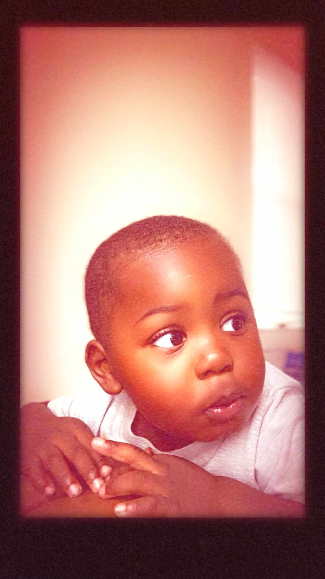 Khimerie is registered to the contest to win money with this photo: toddler, child, face, hands, curious, portrait, indoors, expression, skin, short_hair, looking_away, soft_light, warm_tone, young_child, casual_clothing, resting, human, closeup, person, cute