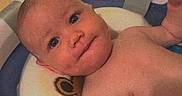 Theo is registered to the contest to win money with this photo: baby, bath, bathroom, child, cute, expression, face, head, indoors, infant, looking, naked, person, portrait, seat, skin, smile, tub, water, young