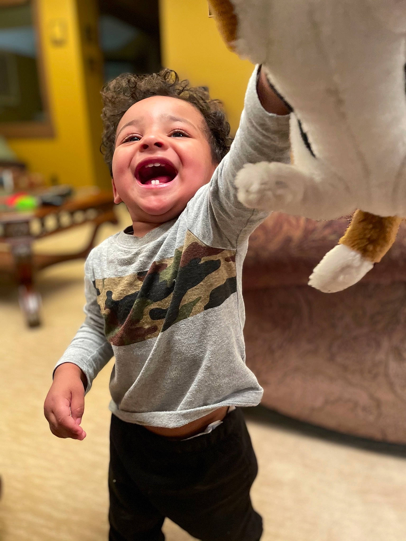 Austyn is registered to the contest to win money with this photo: arm, baby_toddler_clothing, facial_expression, finger, flooring, fun, gesture, hand, happy, head, human_body, joint, leisure, mouth, nose, person, shorts, skin, sleeve, smile