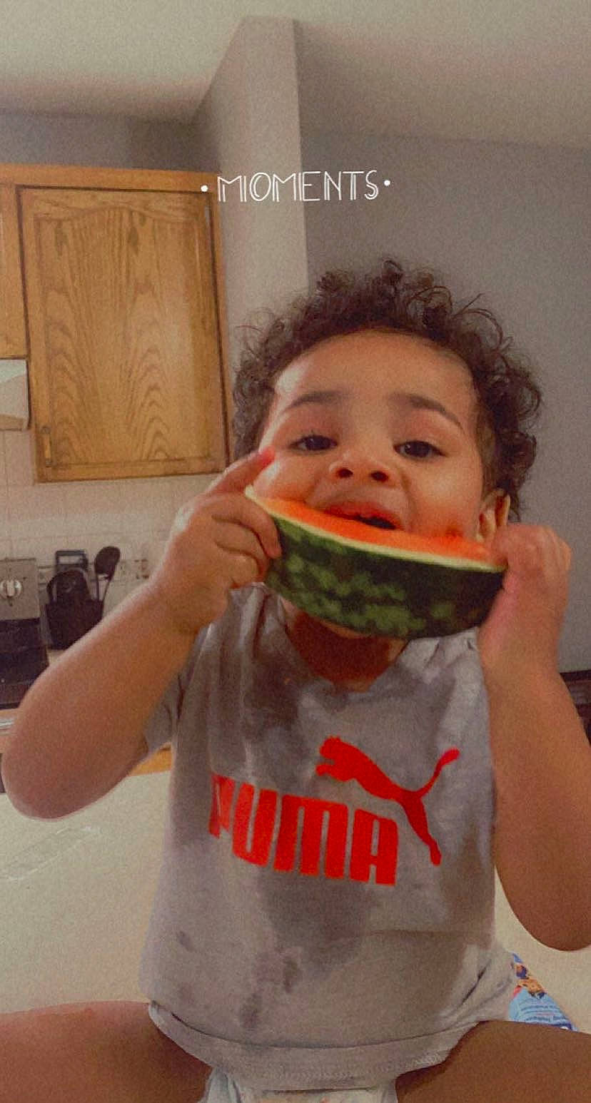 Austyn is registered to the contest to win money with this photo: biting, cabinetry, child, comfort_food, cuisine, drinkware, finger, food, food_craving, gesture, happy, ingredient, jaw, junk_food, kitchen_appliance, mouth, person, staple_food, sweetness, tableware