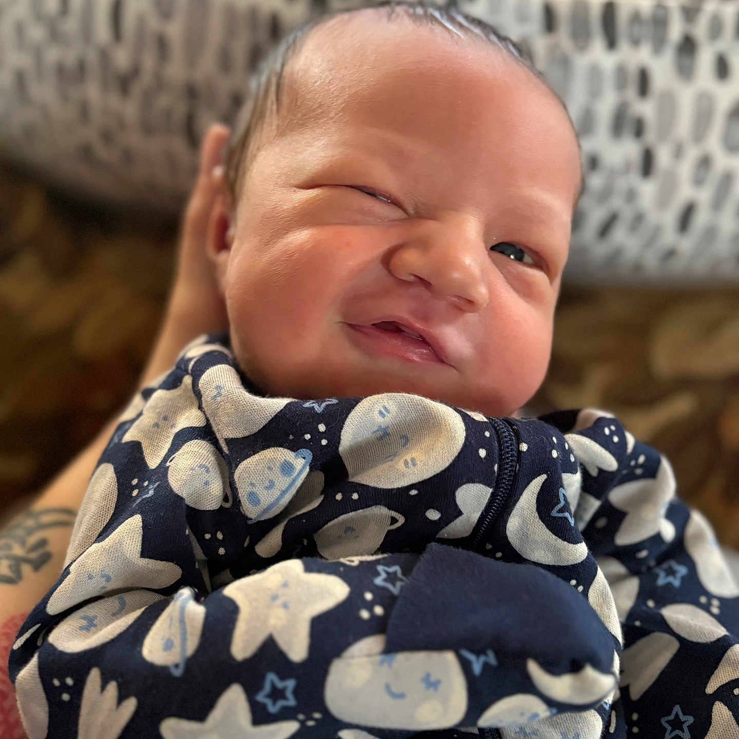 Ian joined the competition — help win amazing prizes! baby, background, child, cozy, cute, expression, face, hand, infant, moon, newborn, pajamas, pattern, person, portrait, skin, sleepwear, stars, tattoo, wrapped