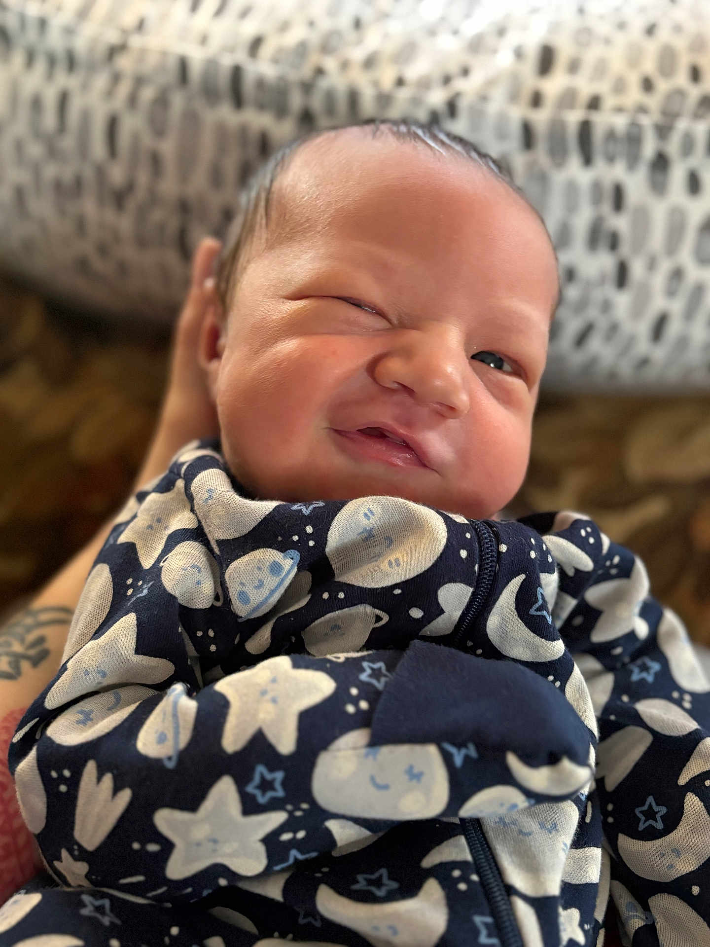 Ian joined the competition — help win amazing prizes! baby, newborn, infant, face, expression, pajamas, stars, moon, hand, tattoo, cozy, sleepwear, cute, portrait, child, person, skin, wrapped, pattern, background